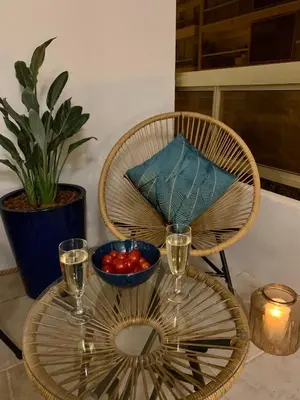 a table with a bowl of tomatoes and glasses of wine at Magnifique 3 pièces en plein cœur de Cannes in Cannes