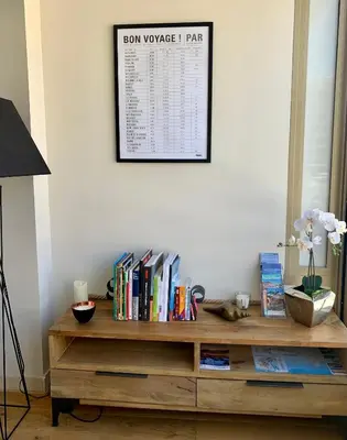 a wooden table with books on it next to a wall at Magnifique 3 pièces en plein cœur de Cannes in Cannes