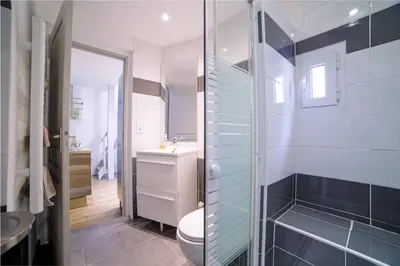 a bathroom with a toilet and a sink at Ô Station Cannes Apartment in Cannes