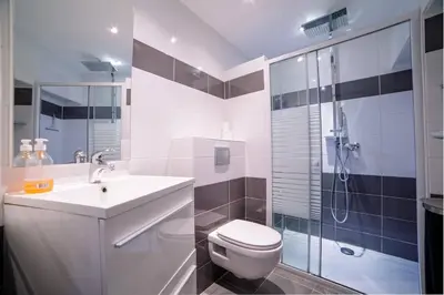 a bathroom with a toilet and a sink and a shower at Ô Station Cannes Apartment in Cannes