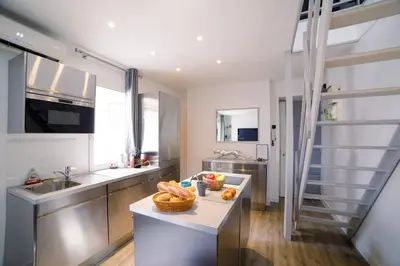 a kitchen with a counter with a bowl of fruit on it at Ô Station Cannes Apartment in Cannes