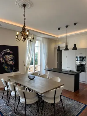 a dining room and kitchen with a table and chairs at Villa Maiffret 1 in Cannes