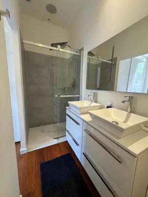a bathroom with two sinks and a shower at Villa Maiffret 1 in Cannes