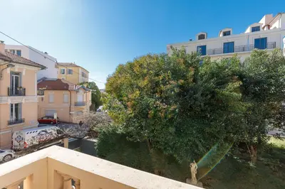a view from a balcony of a tree and buildings at Villa Maiffret 1 in Cannes