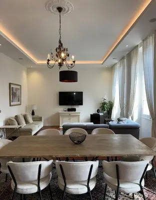 a large living room with a table and chairs at Villa Maiffret 1 in Cannes