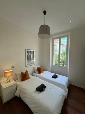 two beds sitting next to each other in a bedroom at Villa Maiffret 1 in Cannes