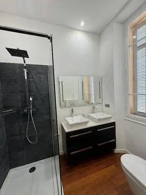 a white bathroom with two sinks and a shower at Villa Maiffret 1 in Cannes