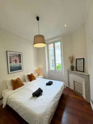 a bedroom with a bed with two dogs laying on it at Villa Maiffret 1 in Cannes