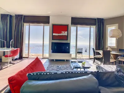 a living room with a couch and a view of the ocean at Un Palais au prix d'un 3 étoiles in Cannes