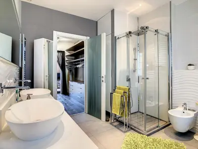 a bathroom with two sinks and a glass shower at Un Palais au prix d'un 3 étoiles in Cannes