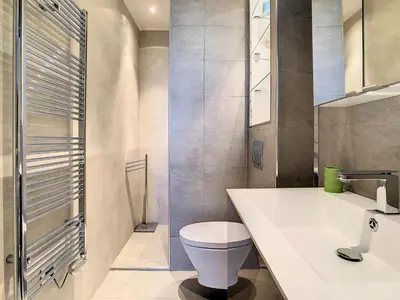 a bathroom with a white toilet and a sink at Un Palais au prix d'un 3 étoiles in Cannes