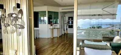 a kitchen with white cabinets and a hard wood floor at 
