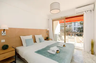 a bedroom with a large bed with towels on it at All Blue YourHostHelper in Cannes