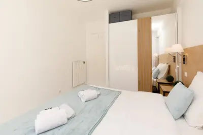 a bedroom with a white bed with two pillows on it at All Blue YourHostHelper in Cannes