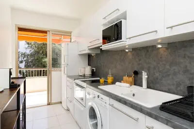a kitchen with a washer and dryer at All Blue YourHostHelper in Cannes