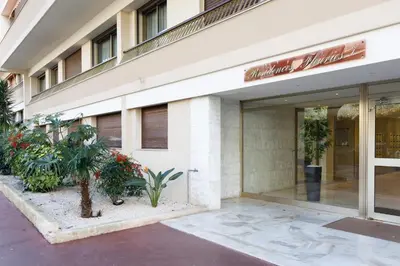 a store front of a building with plants outside at All Blue YourHostHelper in Cannes