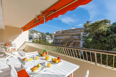 a balcony with a table with fruit on it at All Blue YourHostHelper in Cannes