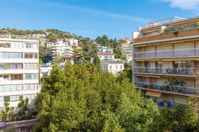 a group of buildings in a city with trees at All Blue YourHostHelper in Cannes