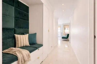 a hallway with a green bench in a house at Luxury Maubourg - Vue mer - Croisette 50m plage - Clim - terrasse in Cannes