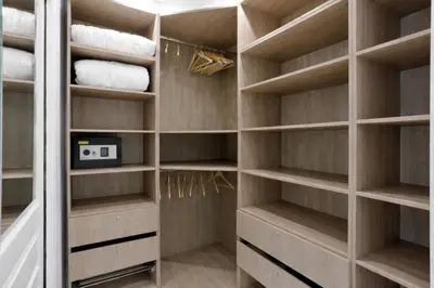 a walk in closet with wooden shelves at Luxury Maubourg - Vue mer - Croisette 50m plage - Clim - terrasse in Cannes