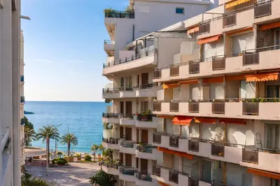 a building with balconies and the ocean in the background at Luxury Maubourg - Vue mer - Croisette 50m plage - Clim - terrasse in Cannes