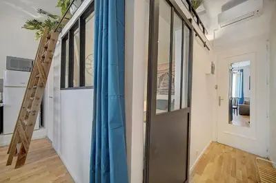 a hallway with a blue curtain and a door at le Clem - 100m des plages - Suquet - Verrière Côte d’Azur in Cannes