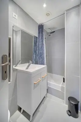 a white bathroom with a sink and a shower at le Clem - 100m des plages - Suquet - Verrière Côte d’Azur in Cannes