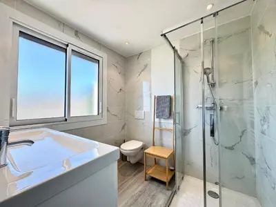a bathroom with a shower and a sink and a toilet at Le Saint-Jean By SCLS Locations in Cannes
