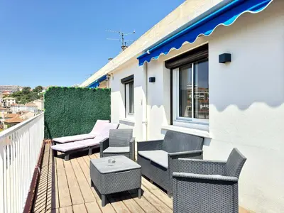 a balcony with chairs and a table on a building at Le Saint-Jean By SCLS Locations in Cannes