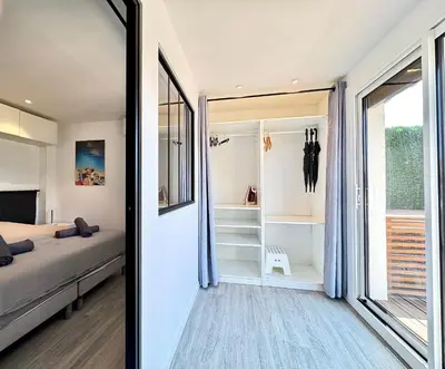 a bedroom with a bed and a large window at Le Saint-Jean By SCLS Locations in Cannes