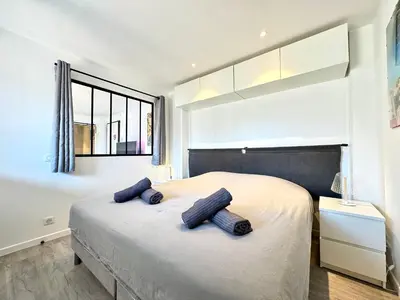 a bedroom with a large bed with two pillows on it at Le Saint-Jean By SCLS Locations in Cannes