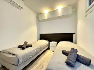 two beds in a room with two brown towels on them at Le Saint-Jean By SCLS Locations in Cannes
