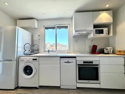 a kitchen with a refrigerator and a washer and dryer at Le Saint-Jean By SCLS Locations in Cannes