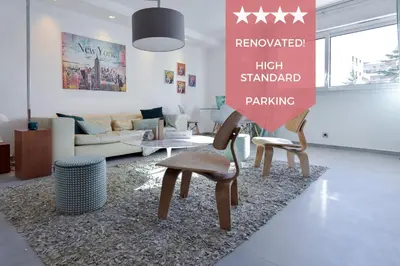 a living room with two chairs and a high standard parking sign at 3-Br Apartment 3 minutes to the Croisette in Cannes