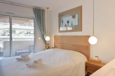 a bedroom with a bed with two towels on it at 3-Br Apartment 3 minutes to the Croisette in Cannes