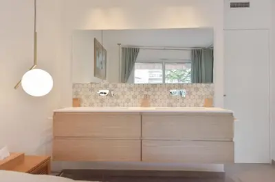 a bathroom with a sink and a mirror at 3-Br Apartment 3 minutes to the Croisette in Cannes