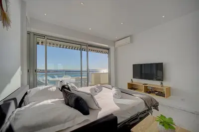 a bedroom with a large bed and a large window at IMMOGROOM- Incredible View -4- Big Terrace - AC - Parking in Cannes