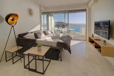 a bedroom with a bed and a view of the ocean at IMMOGROOM- Incredible View -4- Big Terrace - AC - Parking in Cannes