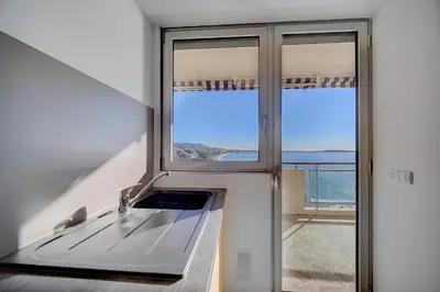 a kitchen with a sink and a large window at IMMOGROOM- Incredible View -4- Big Terrace - AC - Parking in Cannes