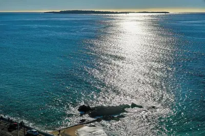 a body of water with the sun shining on the water at IMMOGROOM- Incredible View -4- Big Terrace - AC - Parking in Cannes