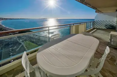 a table and chairs on a balcony with the ocean at IMMOGROOM- Incredible View -4- Big Terrace - AC - Parking in Cannes