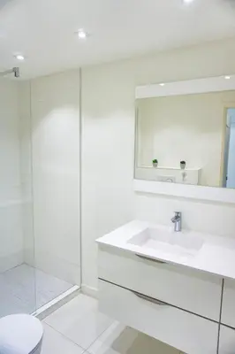 a white bathroom with a sink and a shower at LEM5D - Palmes d'Or Properties in Cannes