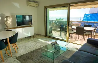 a living room with a couch and a glass table at LEM5F - Palmes d'Or Properties in Cannes