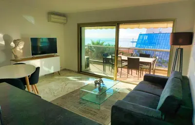a living room with a couch and a glass table at LEM5F - Palmes d'Or Properties in Cannes