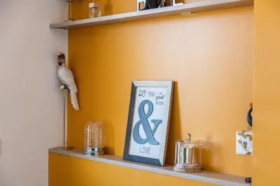 a shelf with a blue sign and a bird on it at LB Vacation Rentals I Cannes Center, Renovated Apartment with Balcony, Ideal for Holidays or Congress! in Cannes