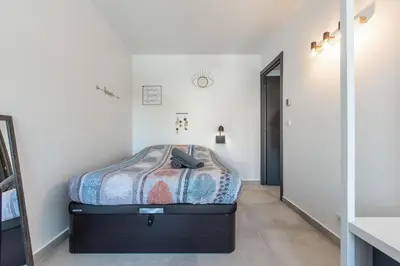 a bedroom with a bed in a room at LB Vacation Rentals I Cannes Center, Renovated Apartment with Balcony, Ideal for Holidays or Congress! in Cannes