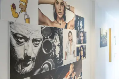 a bunch of pictures hanging on a wall at LB Vacation Rentals I Cannes Center, Renovated Apartment with Balcony, Ideal for Holidays or Congress! in Cannes