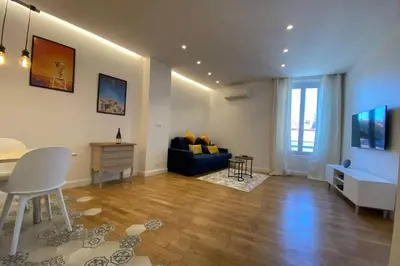 a living room with a blue couch and a table at C016-Magnifique appartement de standing au coeur du Suquet in Cannes