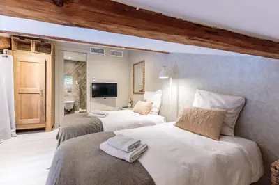 a bedroom with two beds and a television in it at Duplex ForVille in Cannes