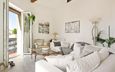 a white living room with a white couch and a table at Duplex ForVille in Cannes